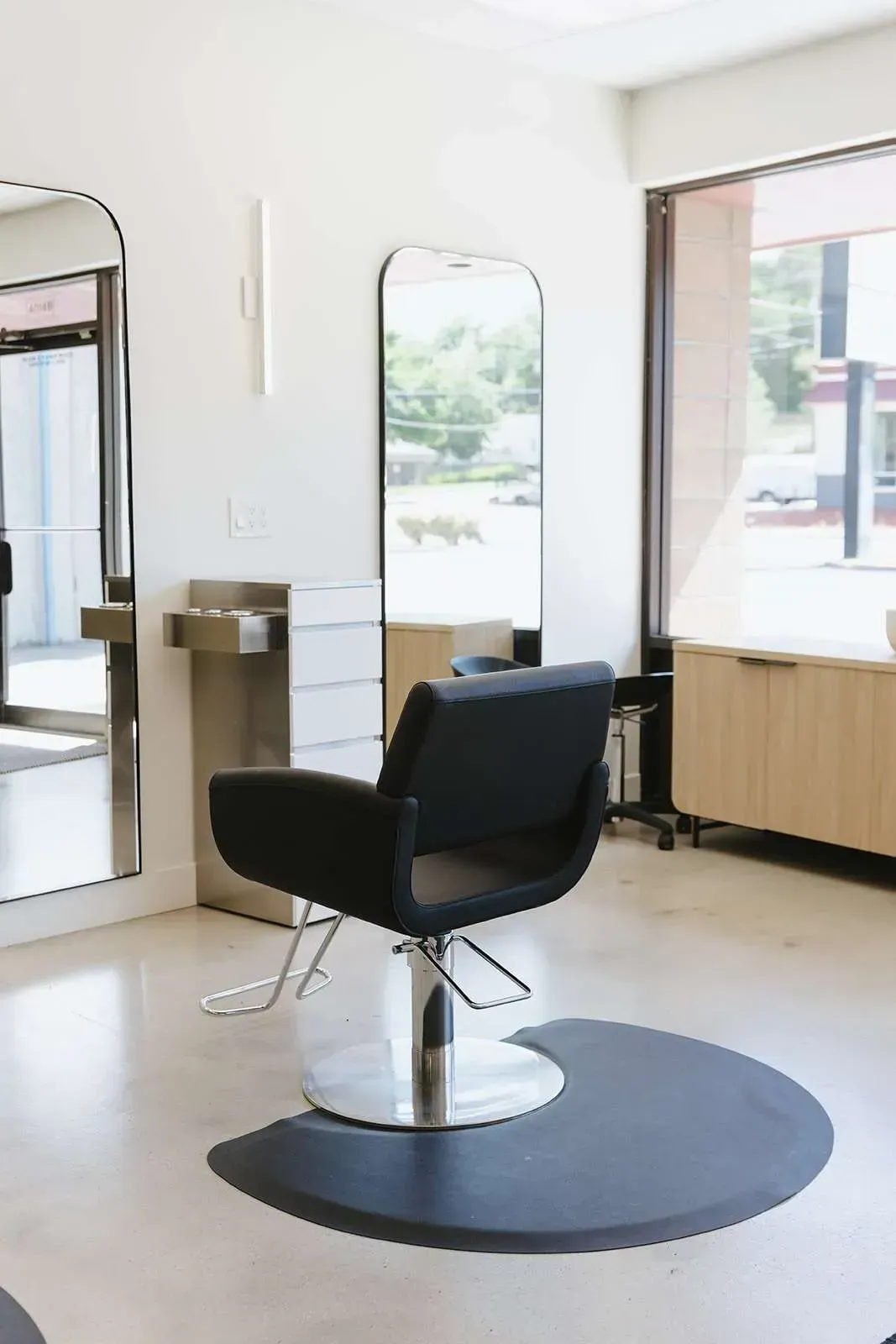 A hair salon with a lot of chairs and mirrors.