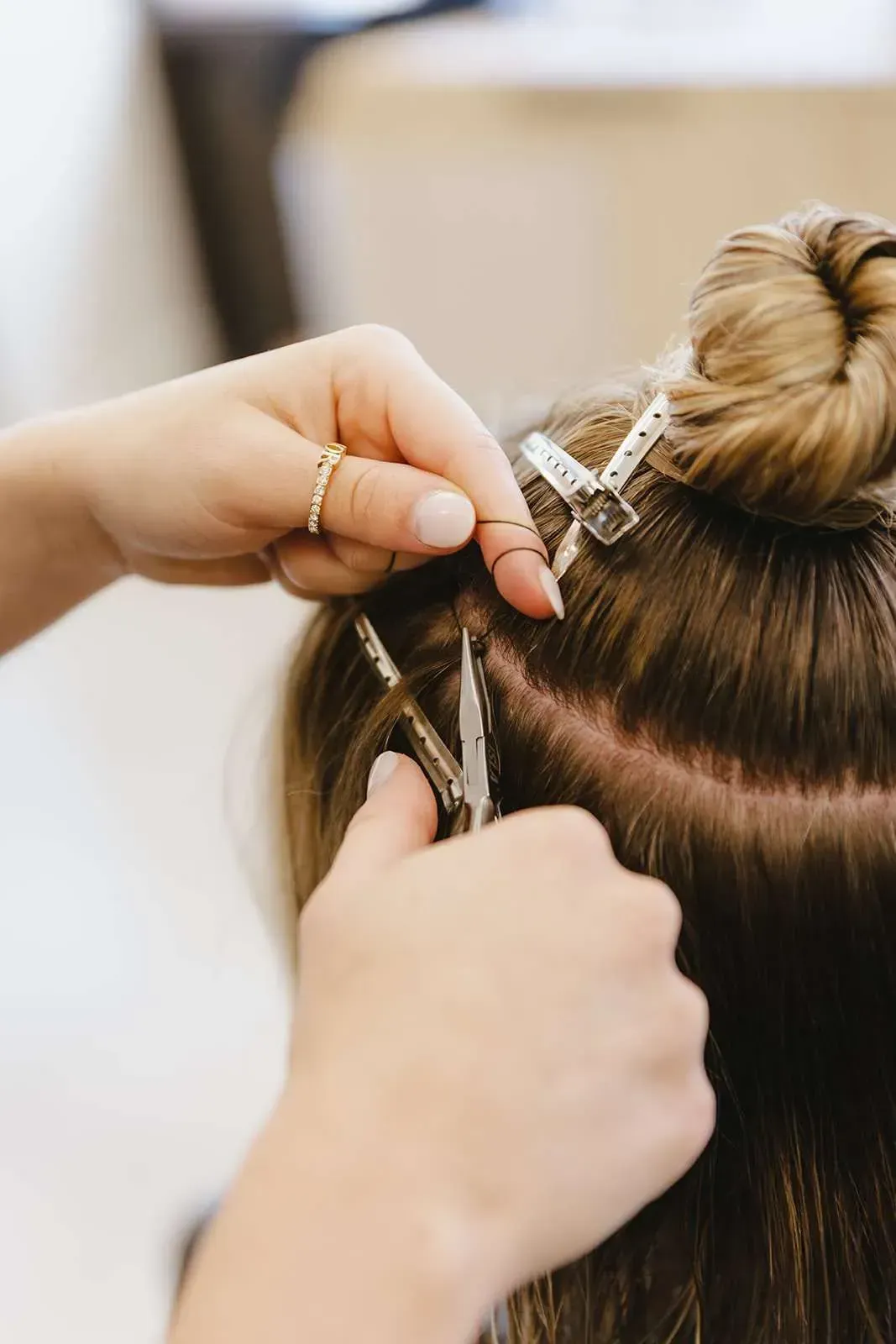 A woman is getting her hair done by a hairdresser.