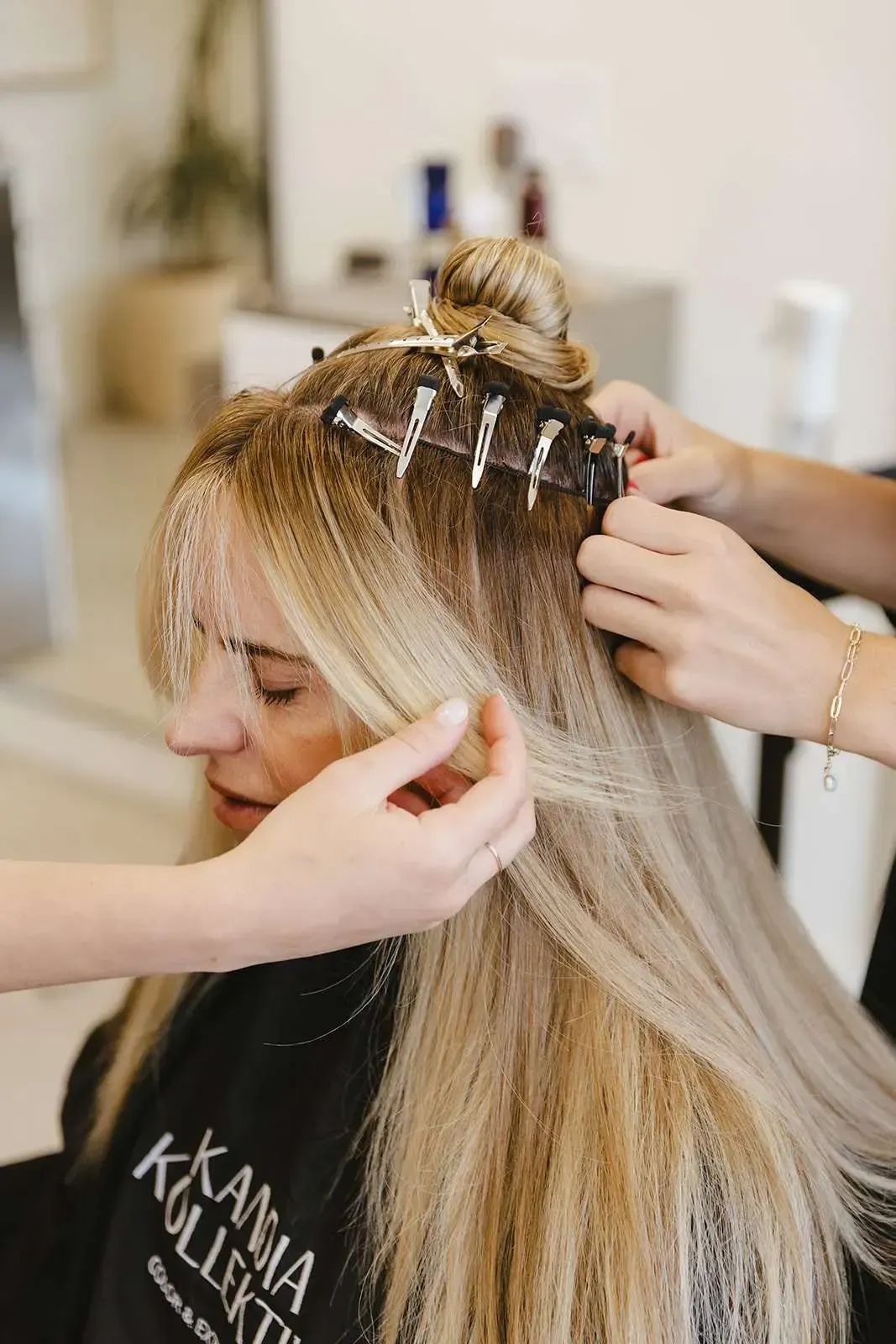 A woman is getting her hair done at a salon.