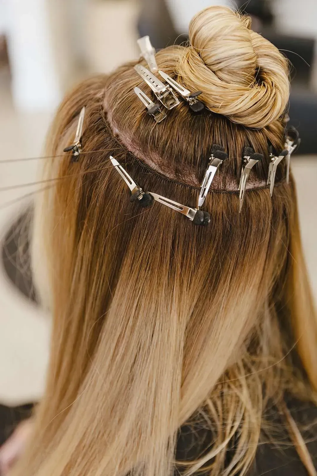 A woman is getting her hair done at a salon.